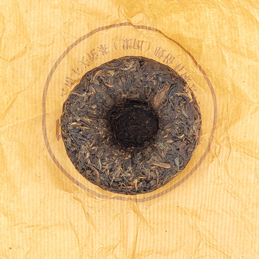 Unwrapped tuo cha pressed raw pu-erh tea
