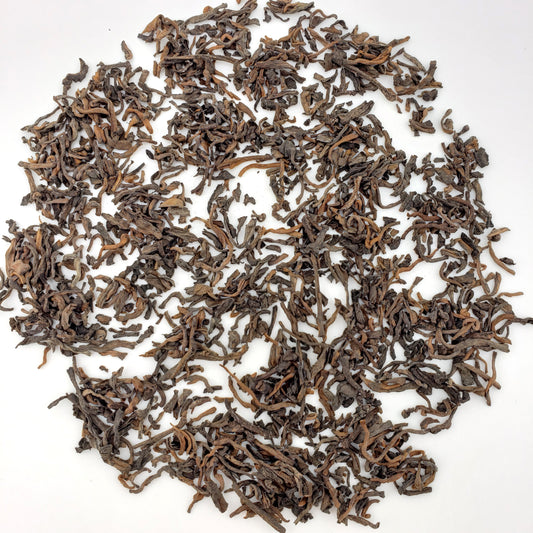 Dry tea leaves on a white background