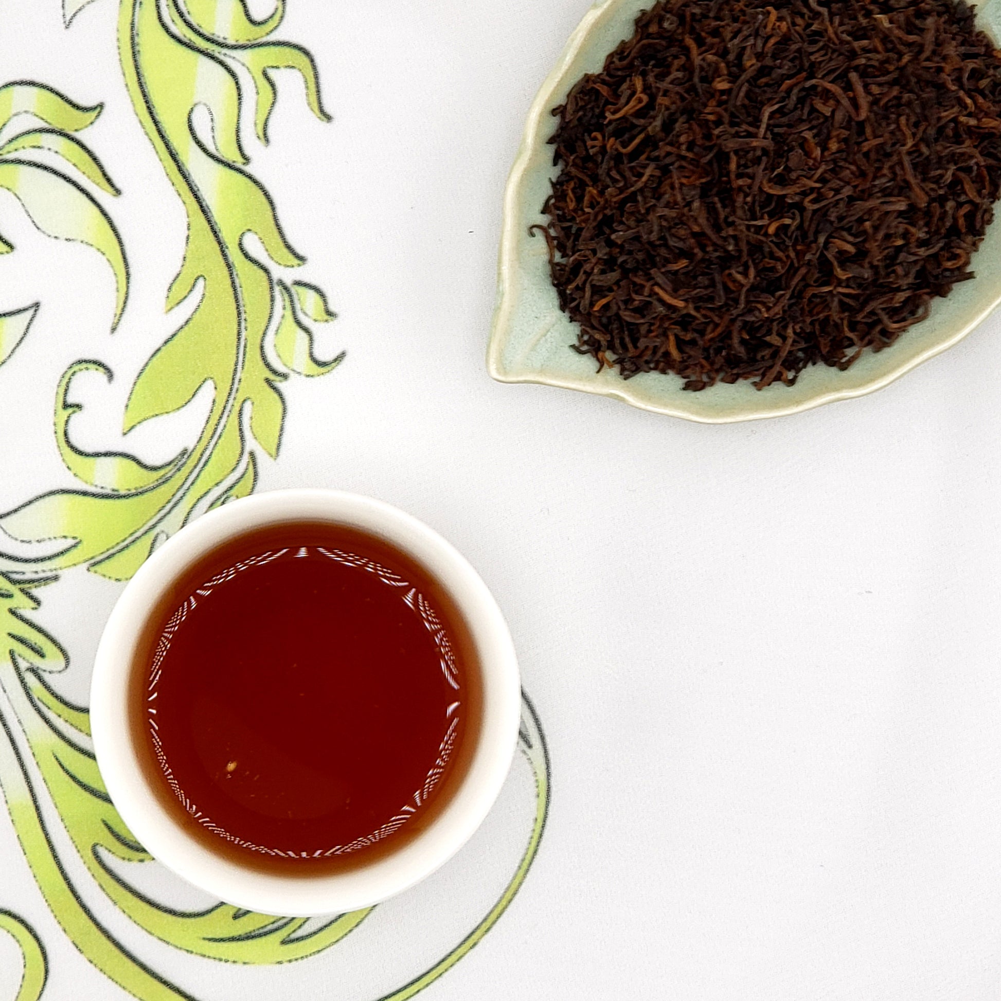 ripe pu-erh tea leaves and a cup of brewed tea