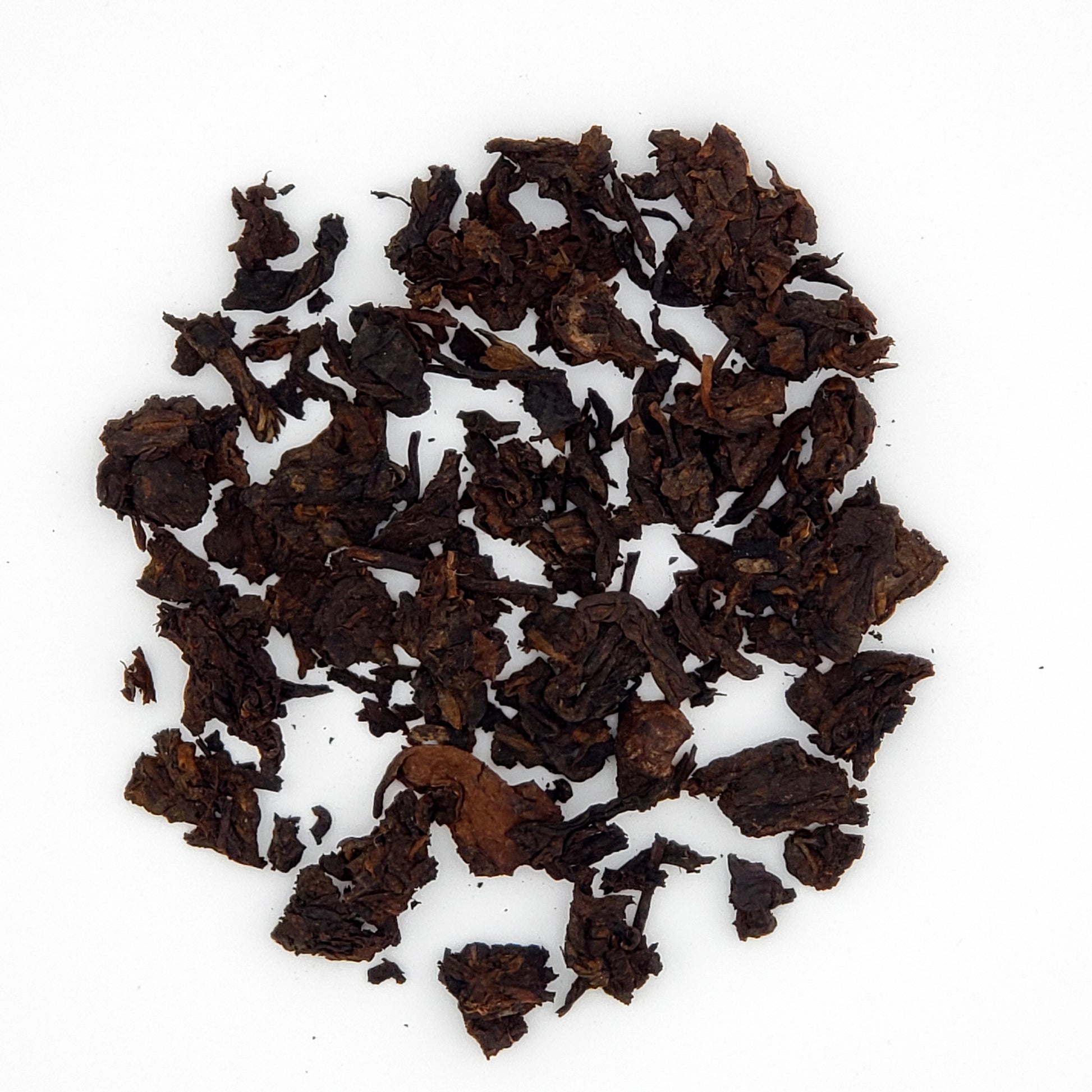 Close up of pu-erh tea leaves broken from the cake