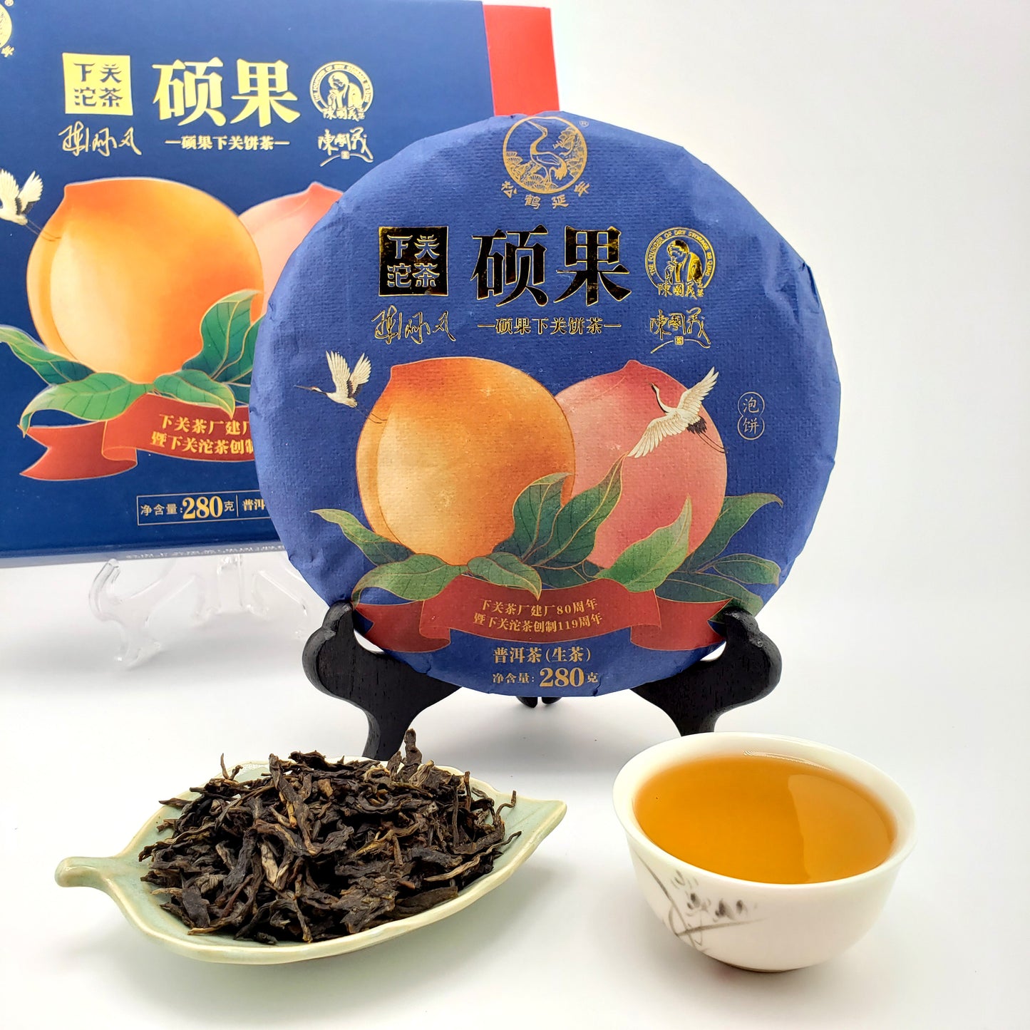 Tea packaging with a teacup and tea leaves on a white background