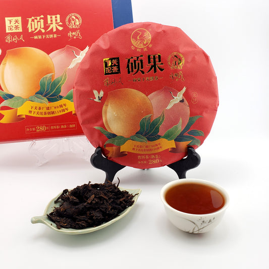 Tea cake packaging with a cup of tea and tea leaves on a white background