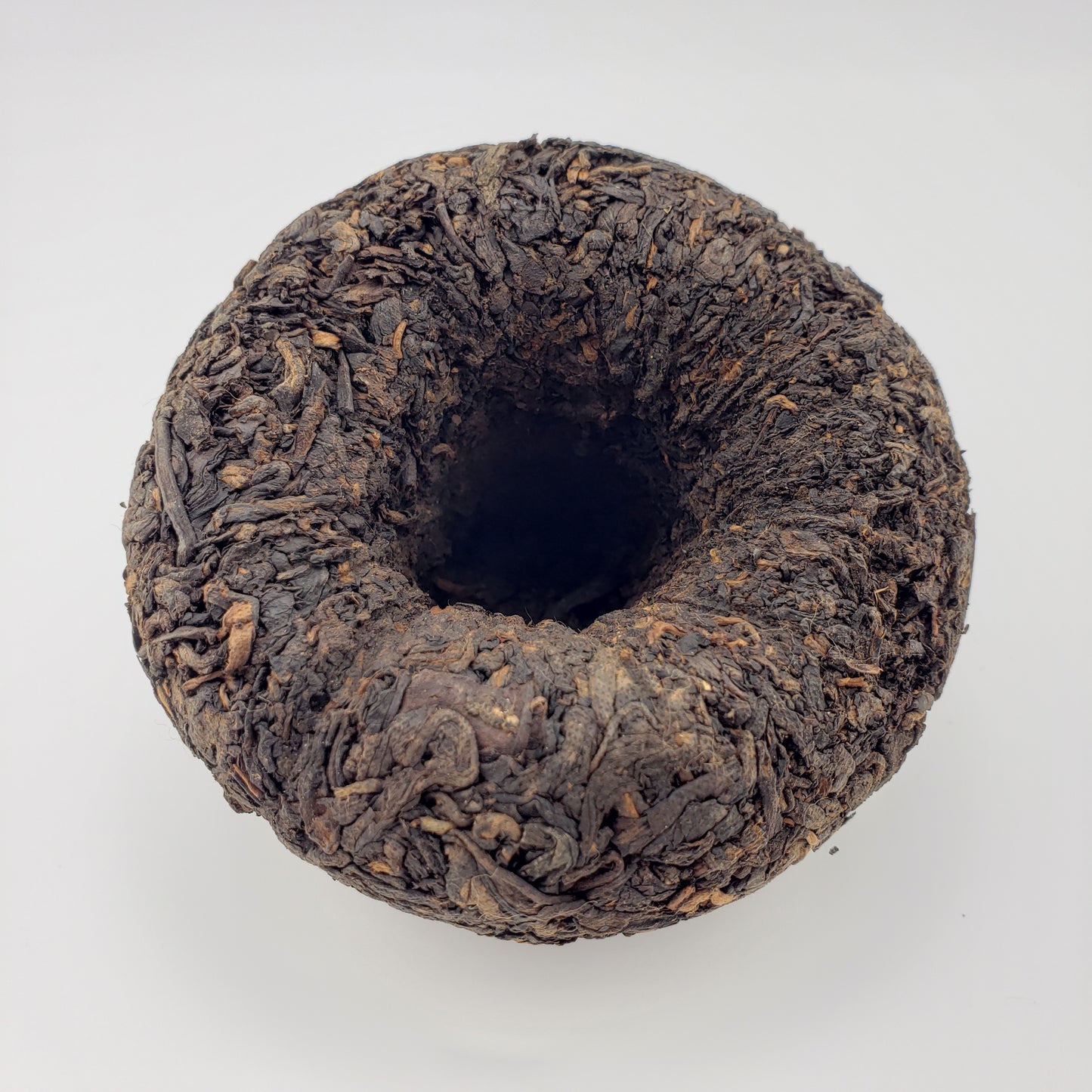 Dark brown tea cake on a white background