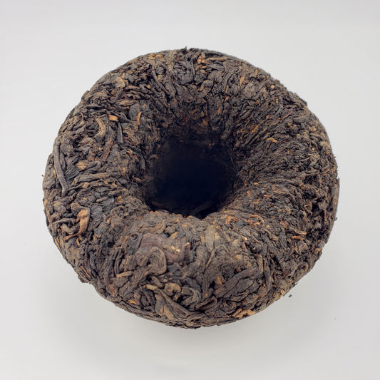 Dark brown tea cake on a white background