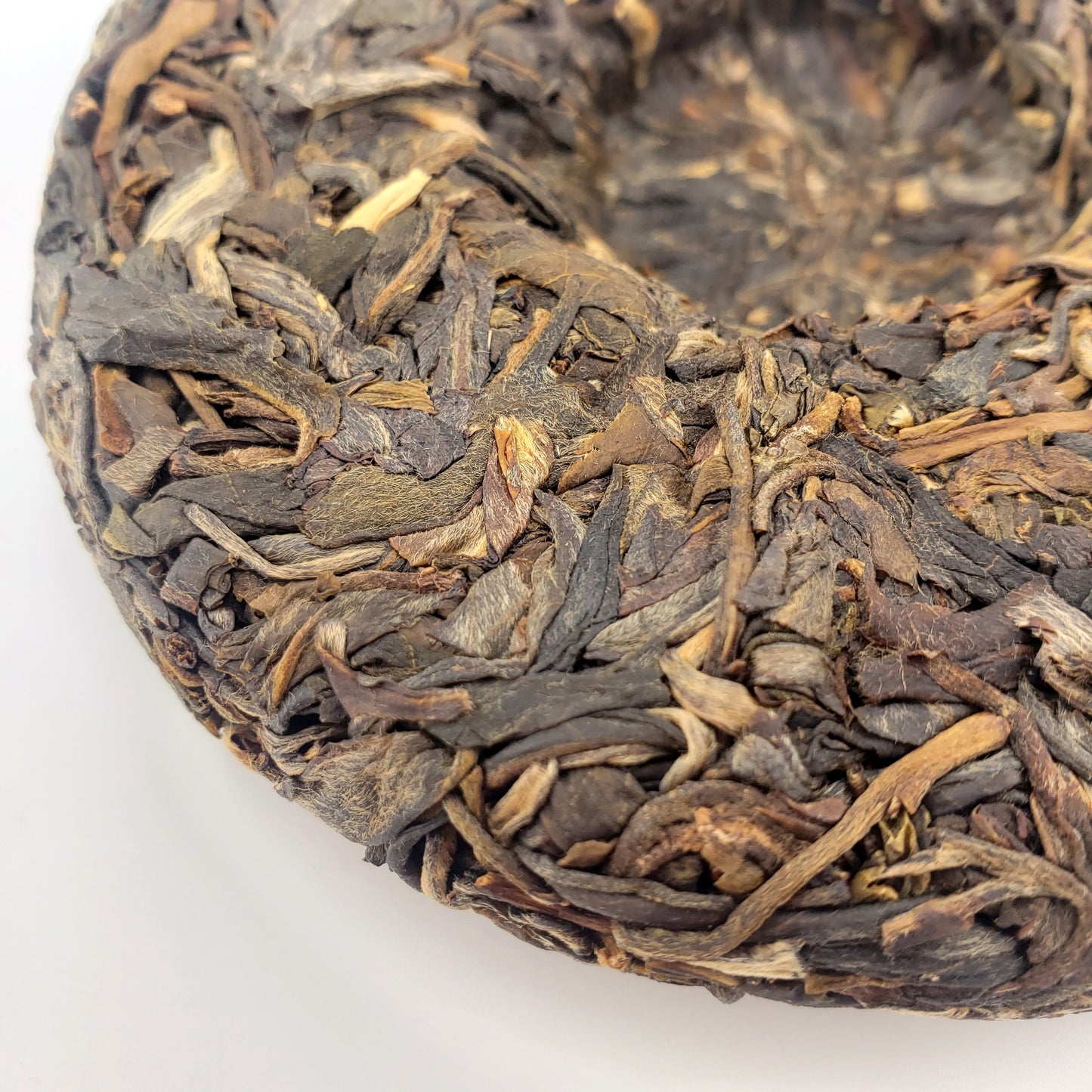 Close-up of dried tea leaves on a white background