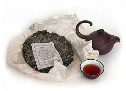 Tea cake, teacup, and teapot on a white background